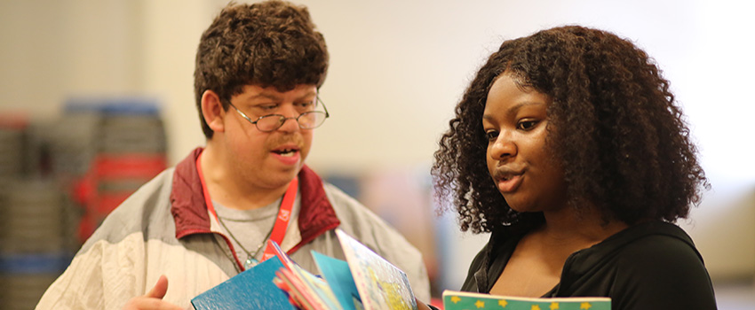 Volunteer reading to another person,