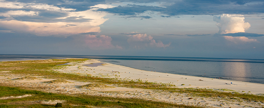 Beach view of sand and water.