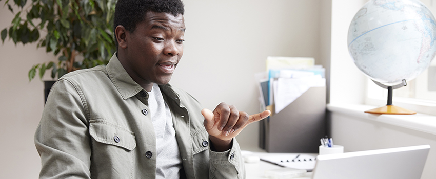 Man using sign language to communicate on a virtual call.