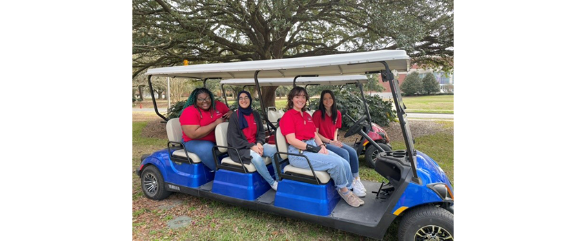 Peer mentors on USA golf cart.
