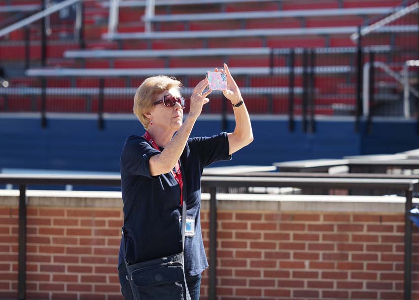 Person taking a picture on the field.