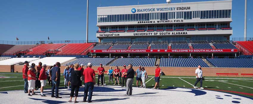 Group in front of stands on football field.