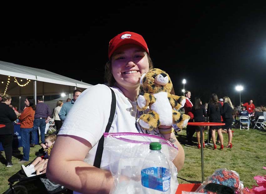 Attendee of the All Class Party 2022 holding a stuffed Southpaw.