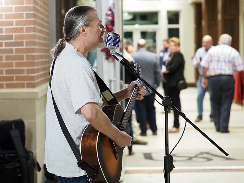 Man playing guitar and singing.