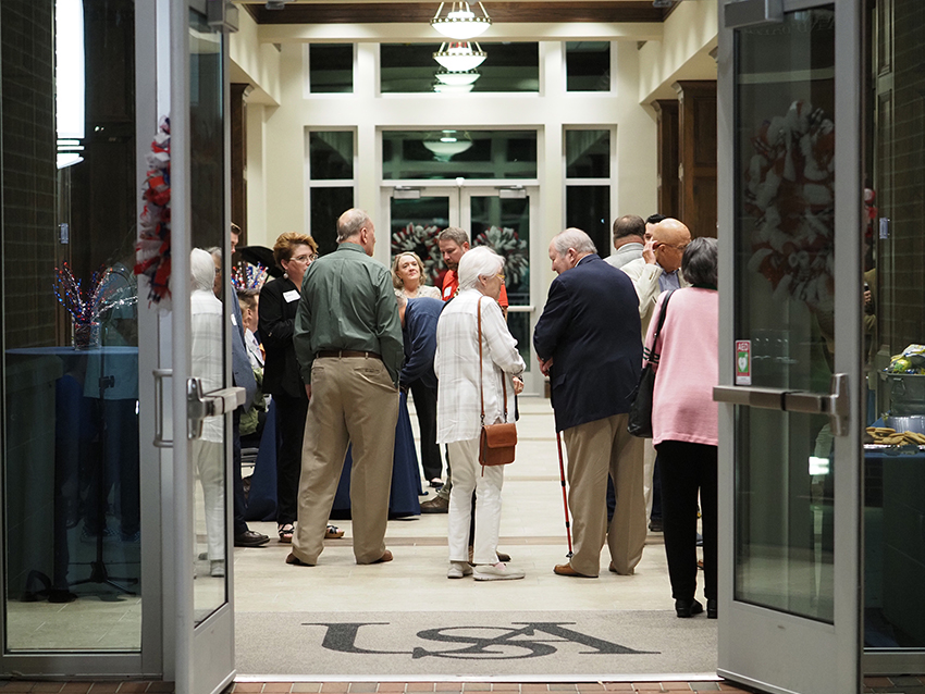 Doors leading into MacQueen Center open showing people inside.