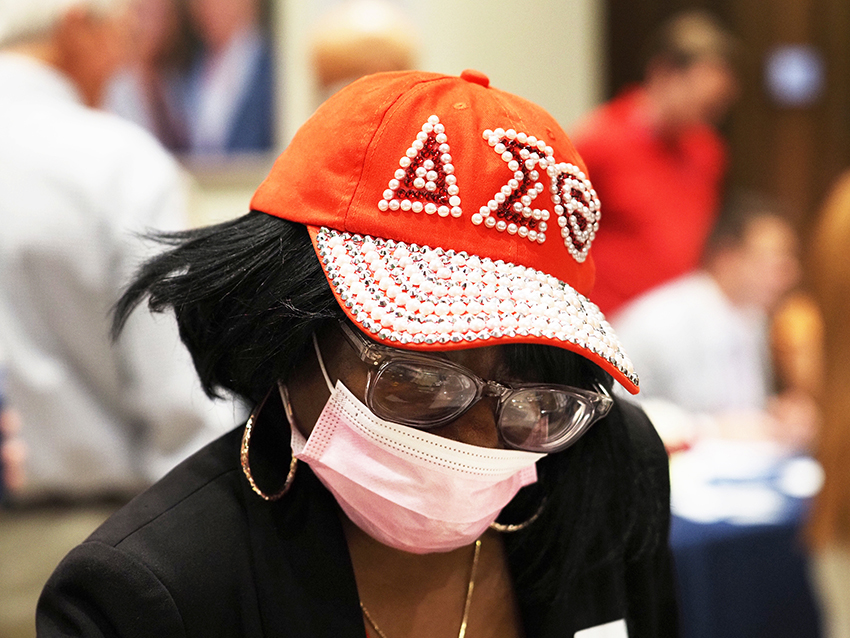 Woman in mask and greek hat.