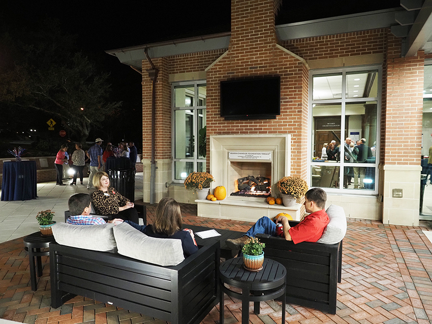 People talking at the outdoor patio at the MacQueen Center.