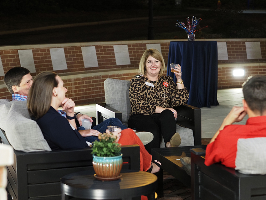 People sitting at the outdoor patio at the MacQueen Center.