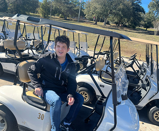 Passage USA Student parking a golf cart at Robert Trent Jones golf course.