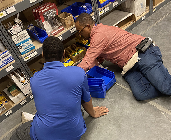 Passage USA student working on stocking shelfs.