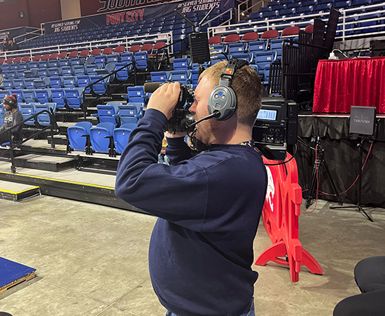 Passage USA Student using a video camera in the Mitchell Center.