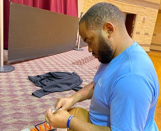 Passage USA student airing up a basketball during their internship.