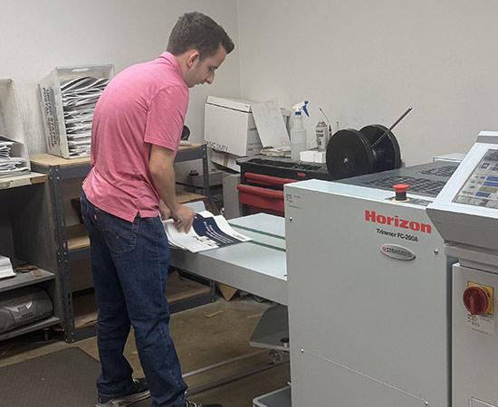 Passage USA Student working at print machine.