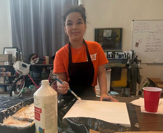 Passage USA student helping paint during their internship.