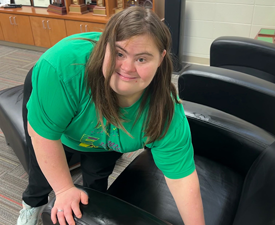 Passage USA student cleaning chair at work,