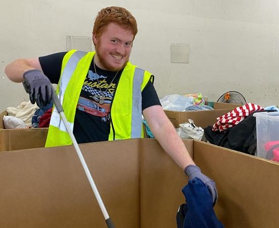 Passage USA student helping assort items during their internship.