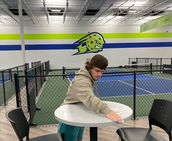 Passage USA student wiping down tables during their internship