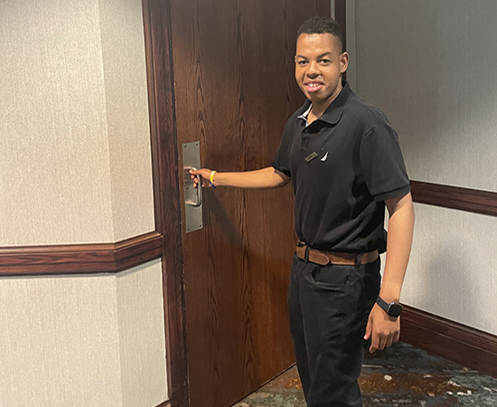 Enrique at work opening door.