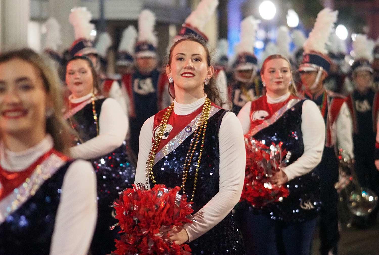 Dance team with pom poms in parade.