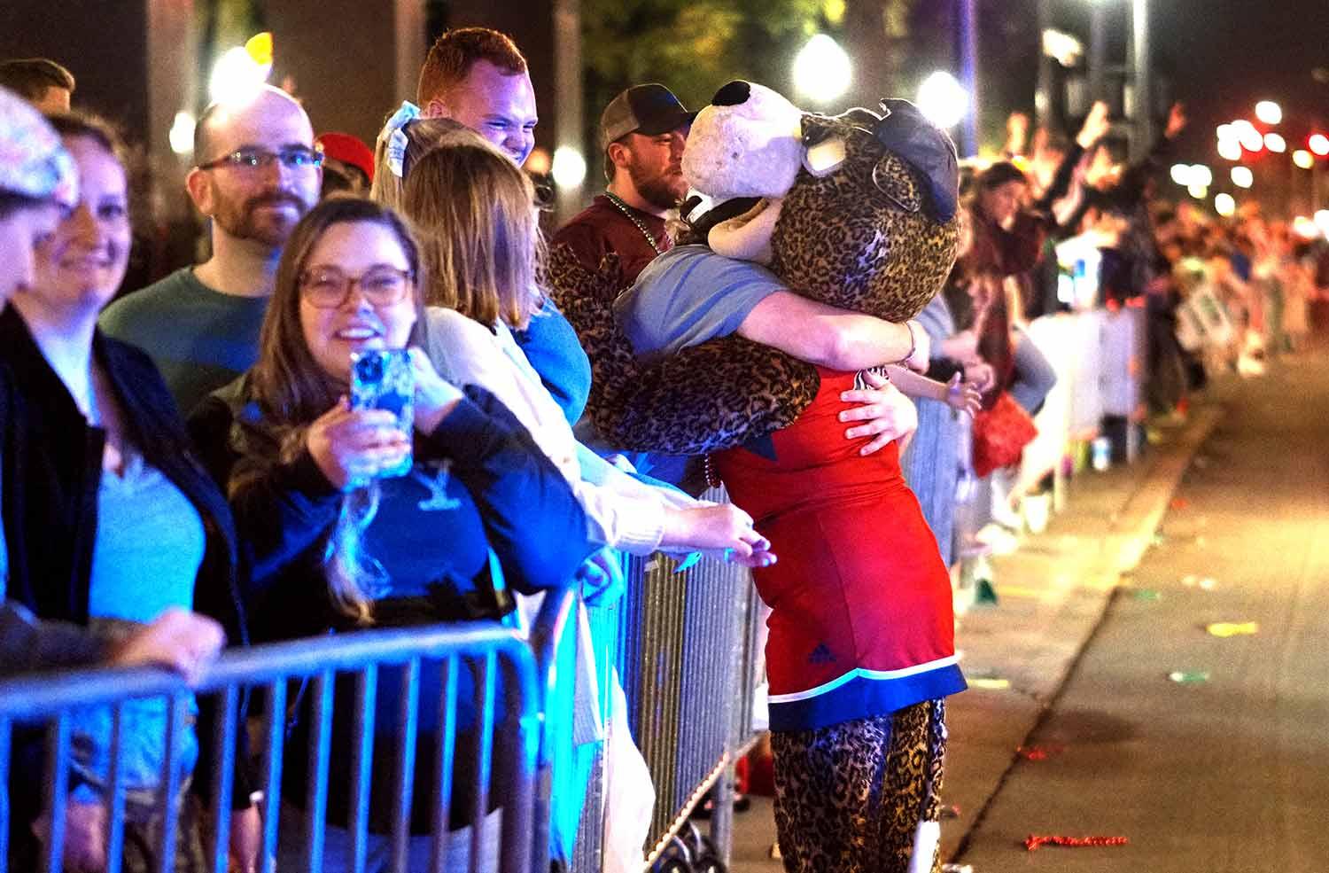 Ms. Pawla hugging someone in the crowd.