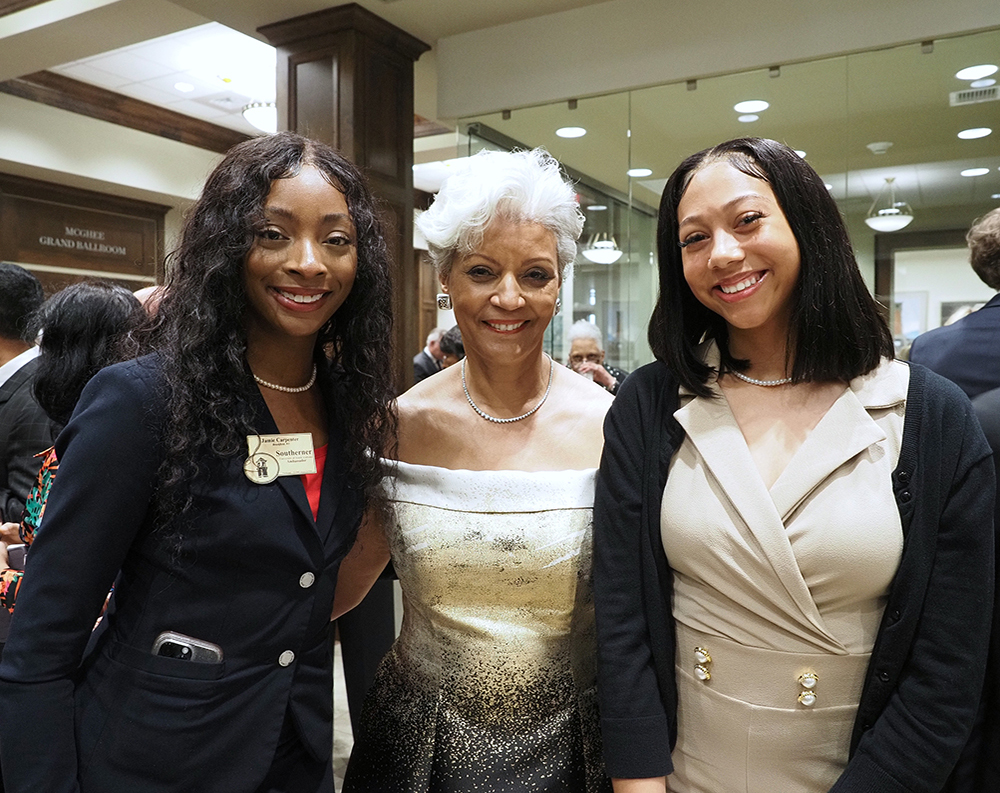 Mrs. Margie Malone Tuckson with two young ladies.