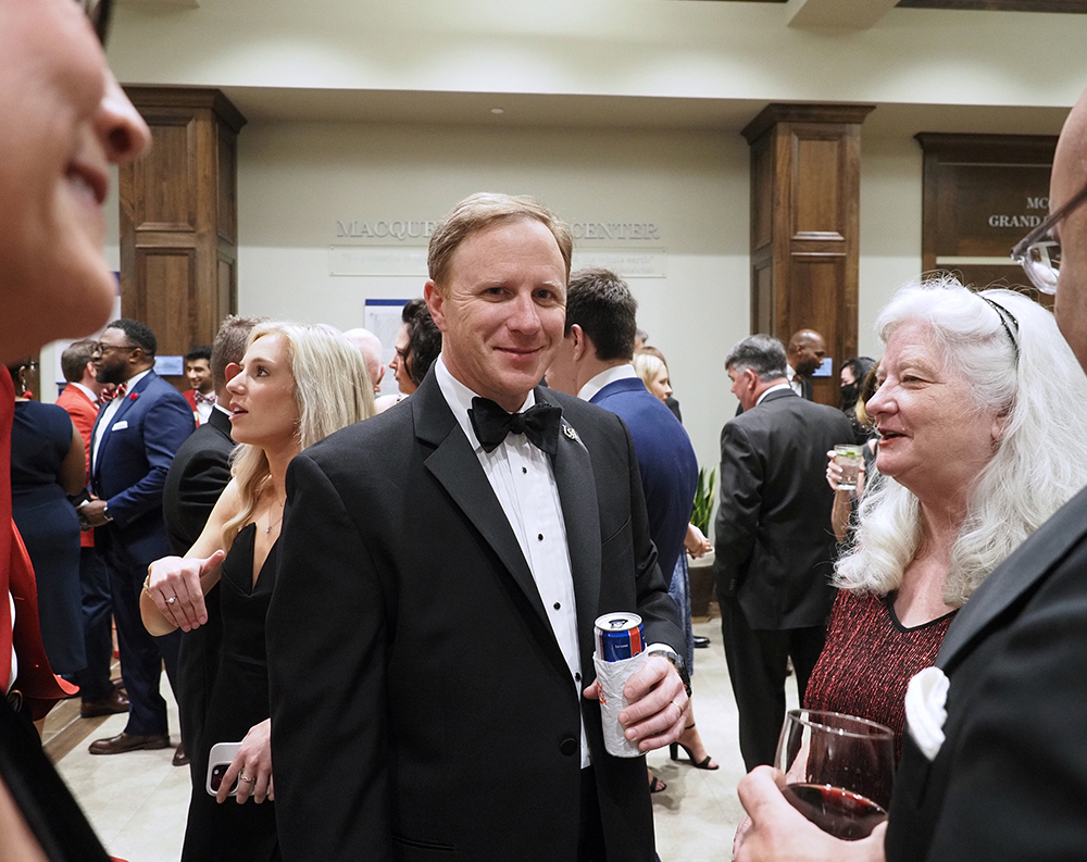 John Ethan Bonds Shell smiling at reception.