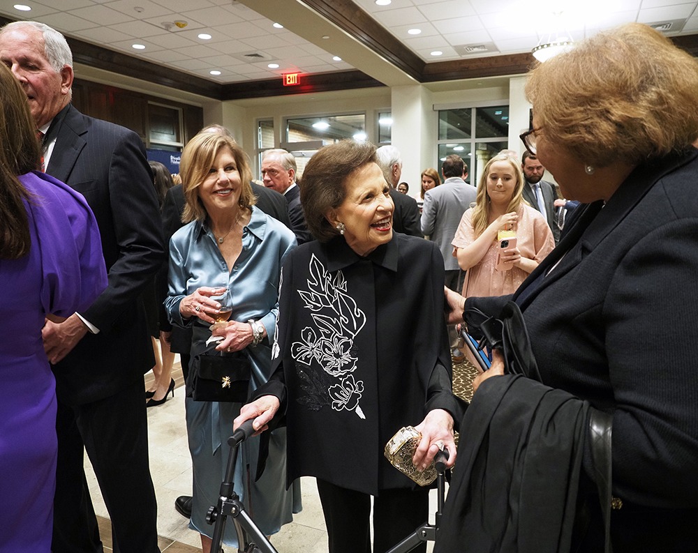 Several people talking at reception.