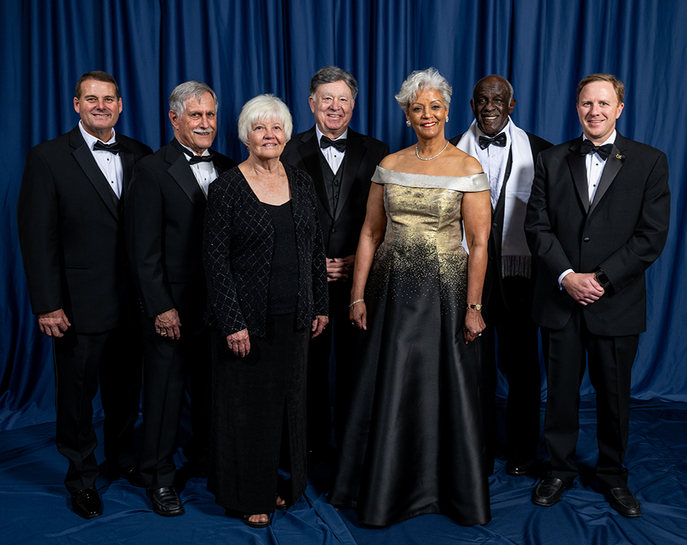 Distinguished Awards recipients in front of blue background.