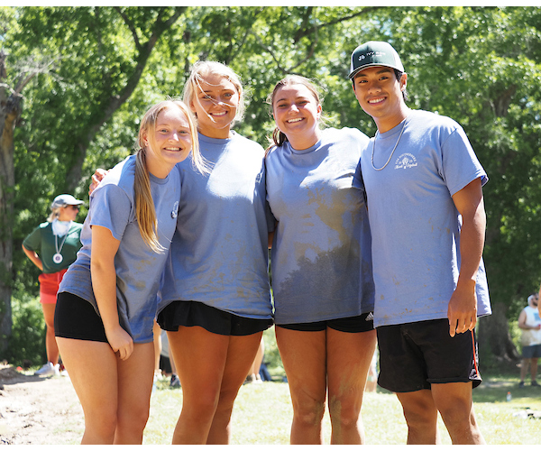 4 students smiling in group picture during oozeball.