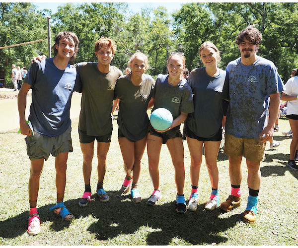 Group image of team at oozeball holding the ball.