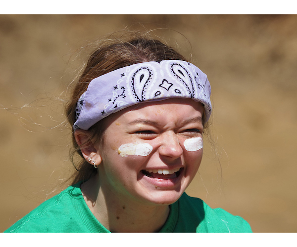 Student with bandana smiling playing oozeball.