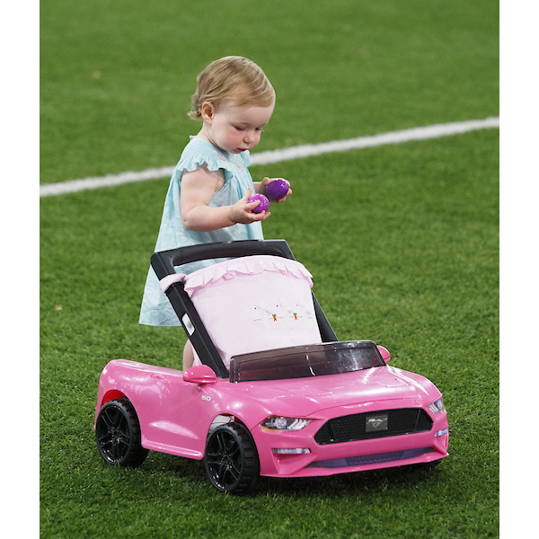 Girl driving a car with a basket across the egg field