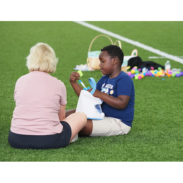 child and parent investigate the contents of various eggs