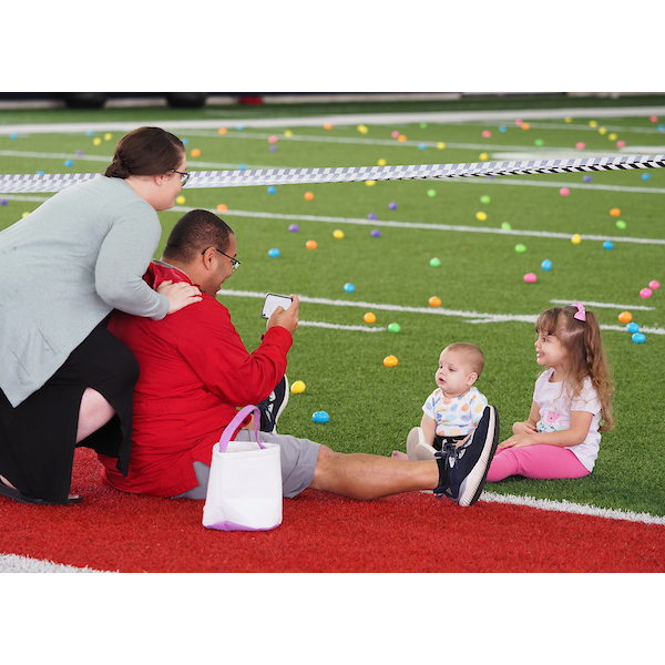 Parents taking pictures of their children on the egg field