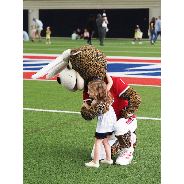 southpaw hugging a child on the egg field