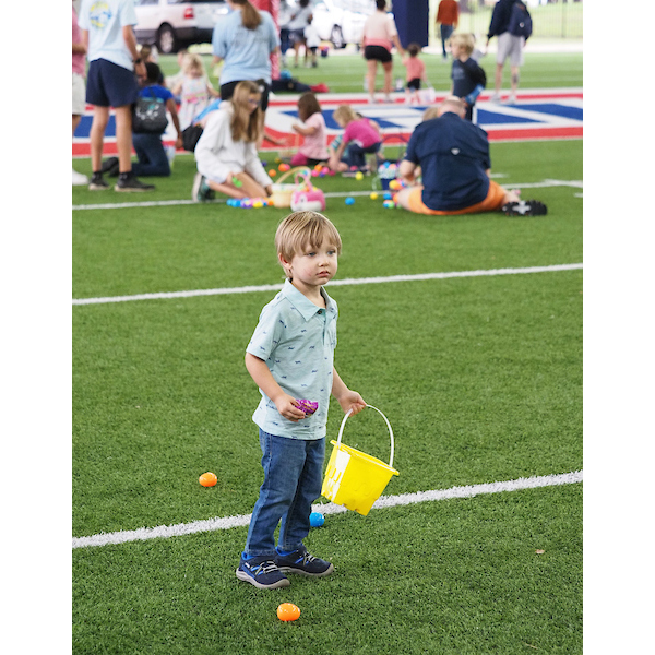 boy looking for something whilst surrounded by eggs