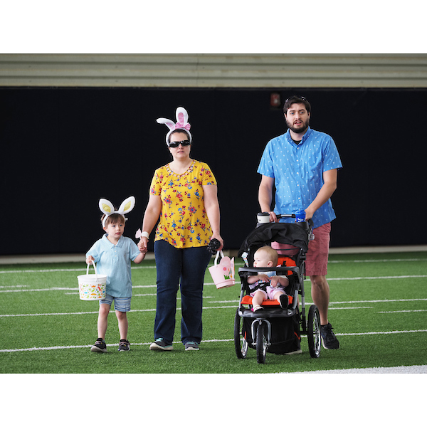 family walking and strolling down the field