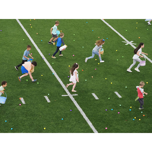 children rush for eggs on the field