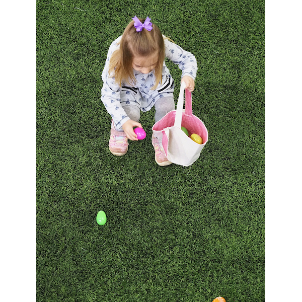 girl quickly tossing eggs into her basket