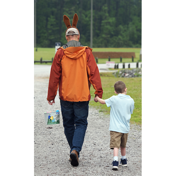 son and father walking home after a good egg hunt