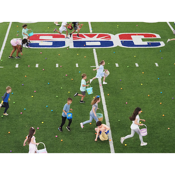 children racing down the egg field