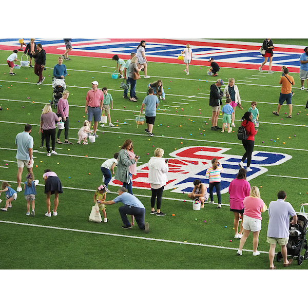 children and parents walking together on the egg field