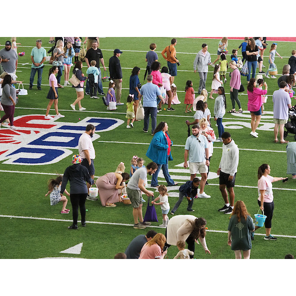parents and children gathering on the football field