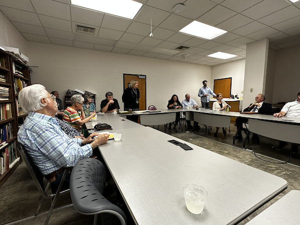 picture of the port city craftsman check meeting, several people presenting and speaking