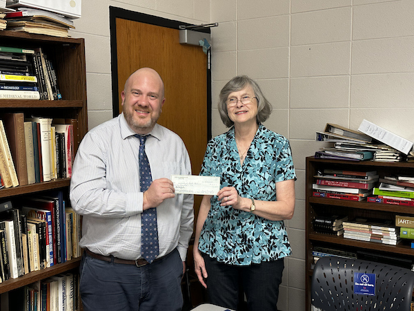 passing of a check from the port city craftsman check organization to the USA Art Department