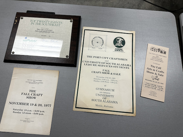 Historical fliers and plaques from previous port city craftsman check presentations