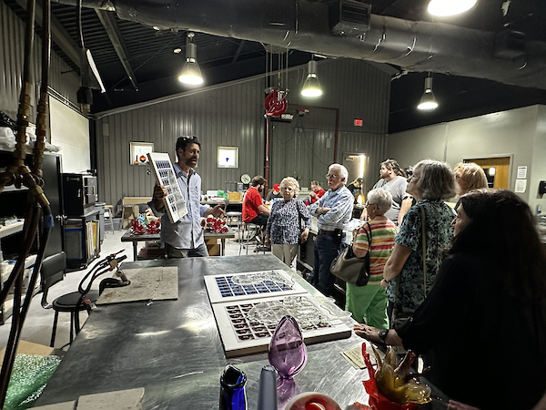 glass craftsman demonstrating the different types of glass he produces