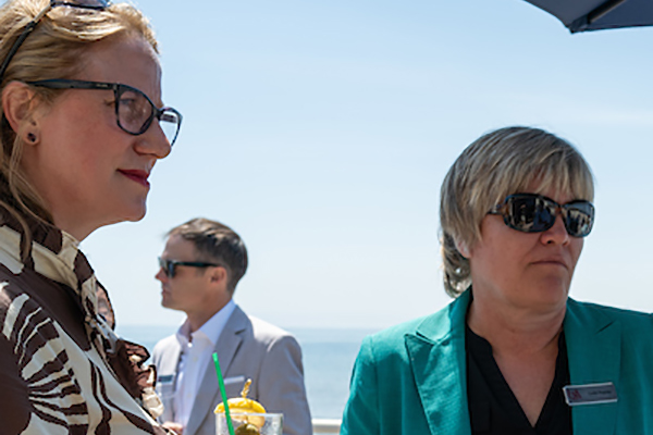 Two women listening to someone talk.