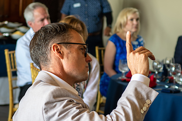 Attendee raising his hand for a question