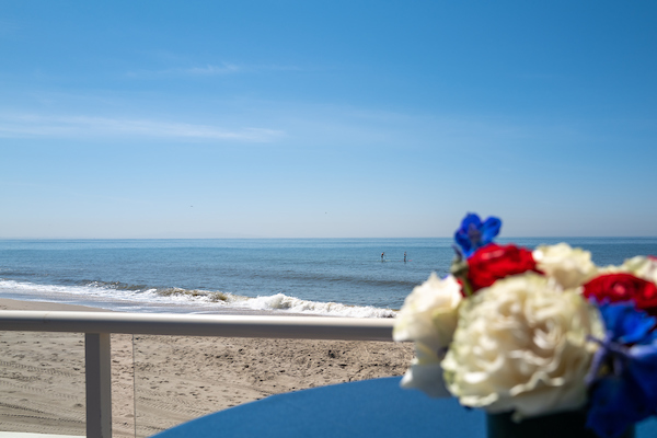 shot of the Californian coast with a set of flowers in front